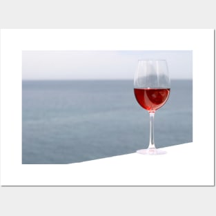 Glass of wine with sea in background Posters and Art